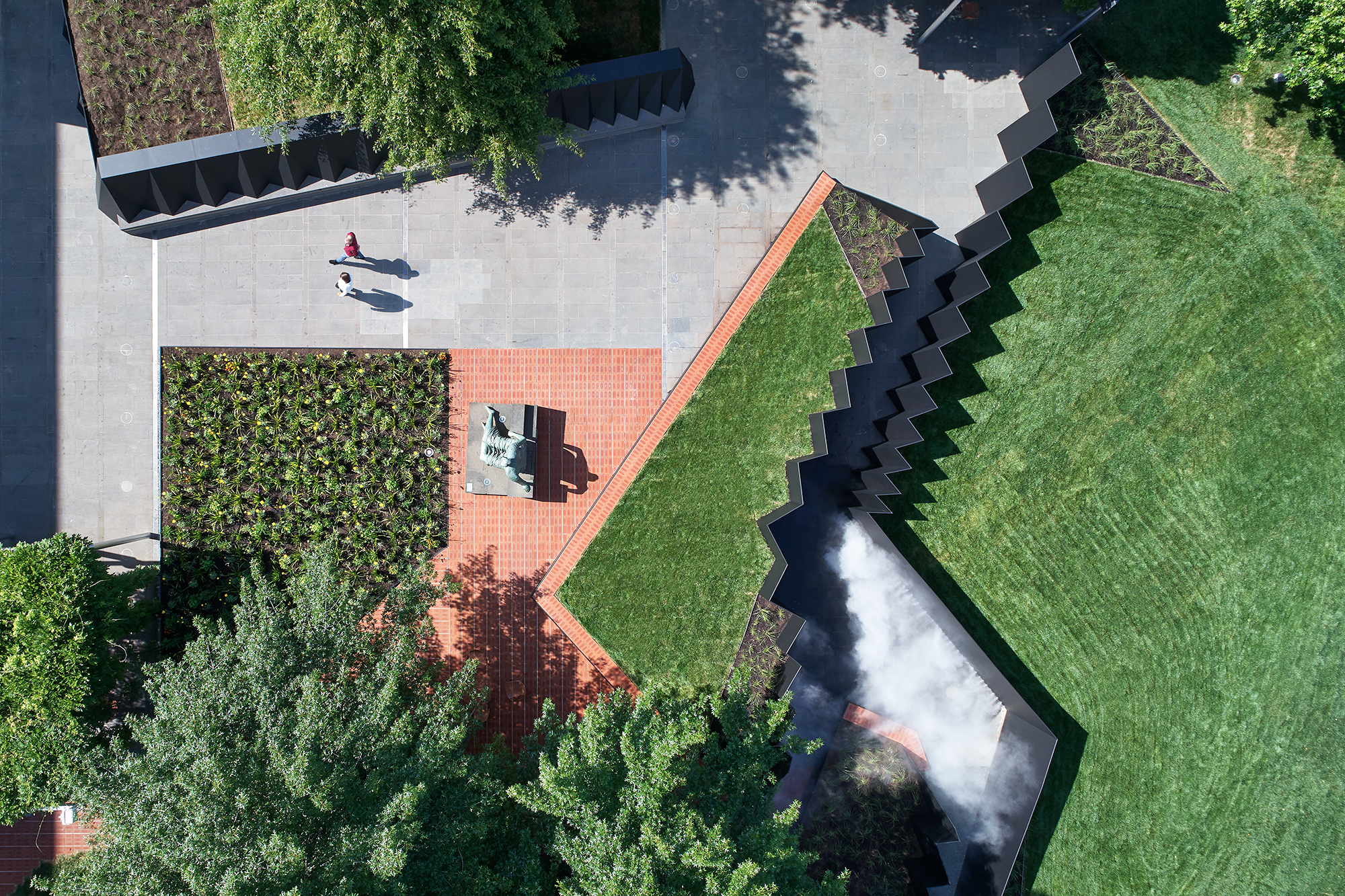 Doubleground transforms the NGV’s Grollo Equiset Garden with a site-specific work of temporary architecture by literally raising sections of the landscape and creating chasm-like passageways for visitors to explore between the tilted embankments.